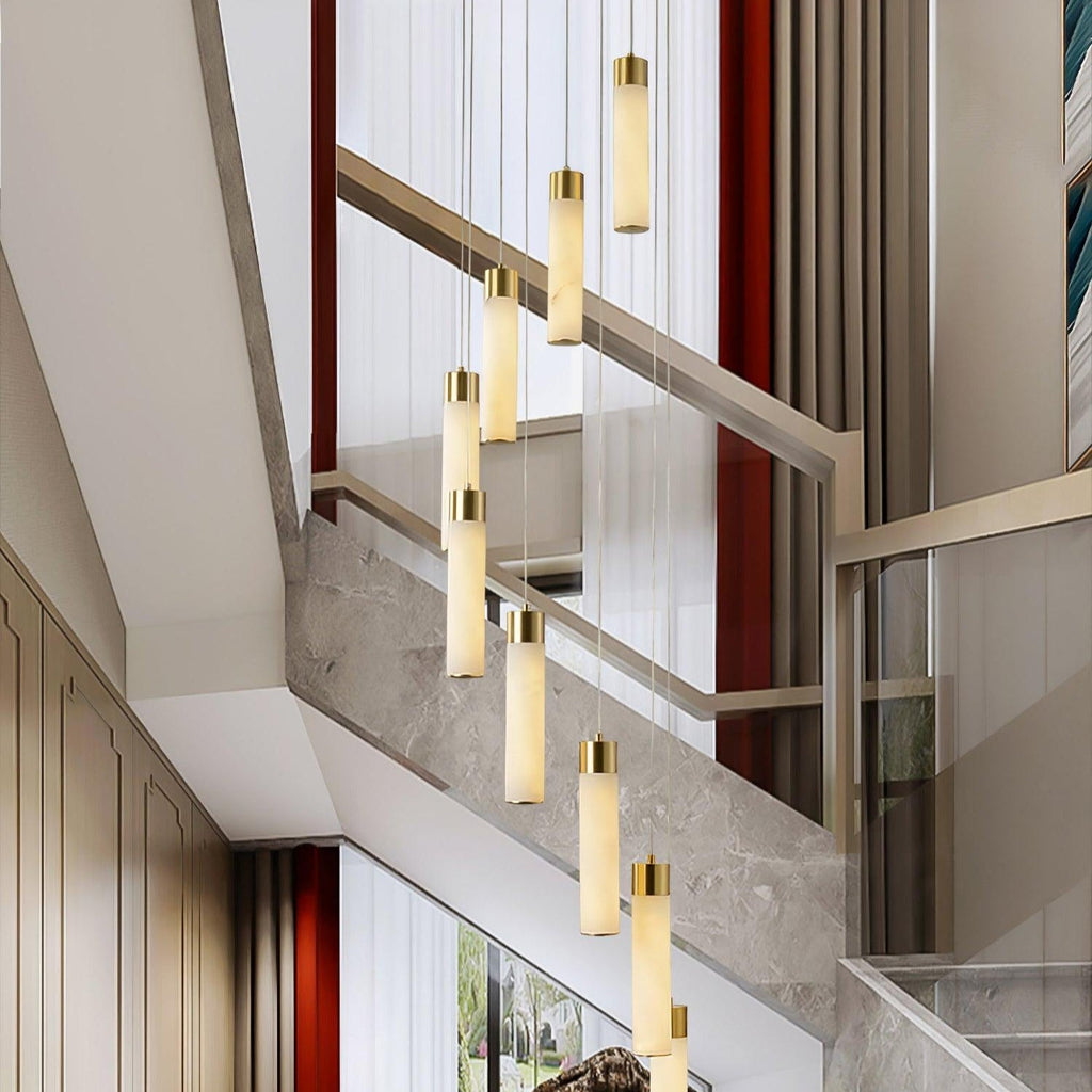 Aurelia cascade in a double-height entrance hall, hanging beside a marble and glass staircase.