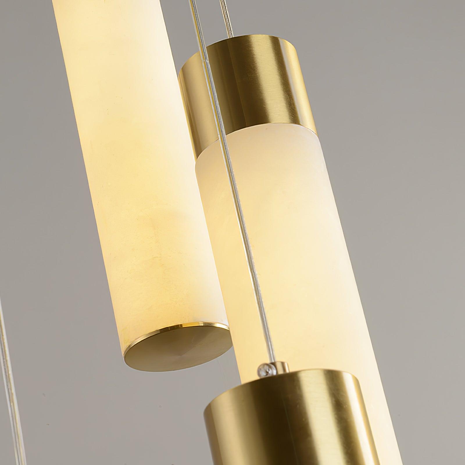 Extreme close-up of two alabaster rods and their brushed brass end caps.