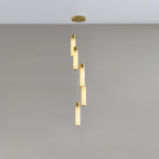 Five alabaster rods with brass collars hung in a loose spiral from a round ceiling plate.
