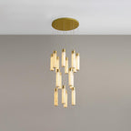 A compact cluster of alabaster rods hung close together at staggered heights on grey.
