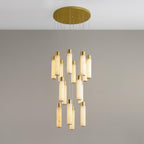 A fifteen-rod cluster on grey, the tubes lit so their alabaster grain shows.