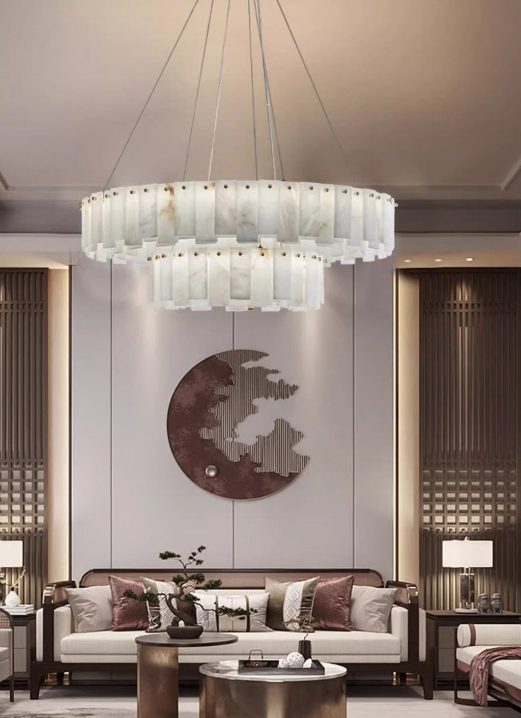 Aero round chandelier lit above a living room sofa, hung high beneath a recessed ceiling