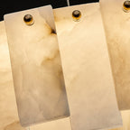 Tight crop of the Aero chandelier lit, showing light passing through the veined alabaster panels