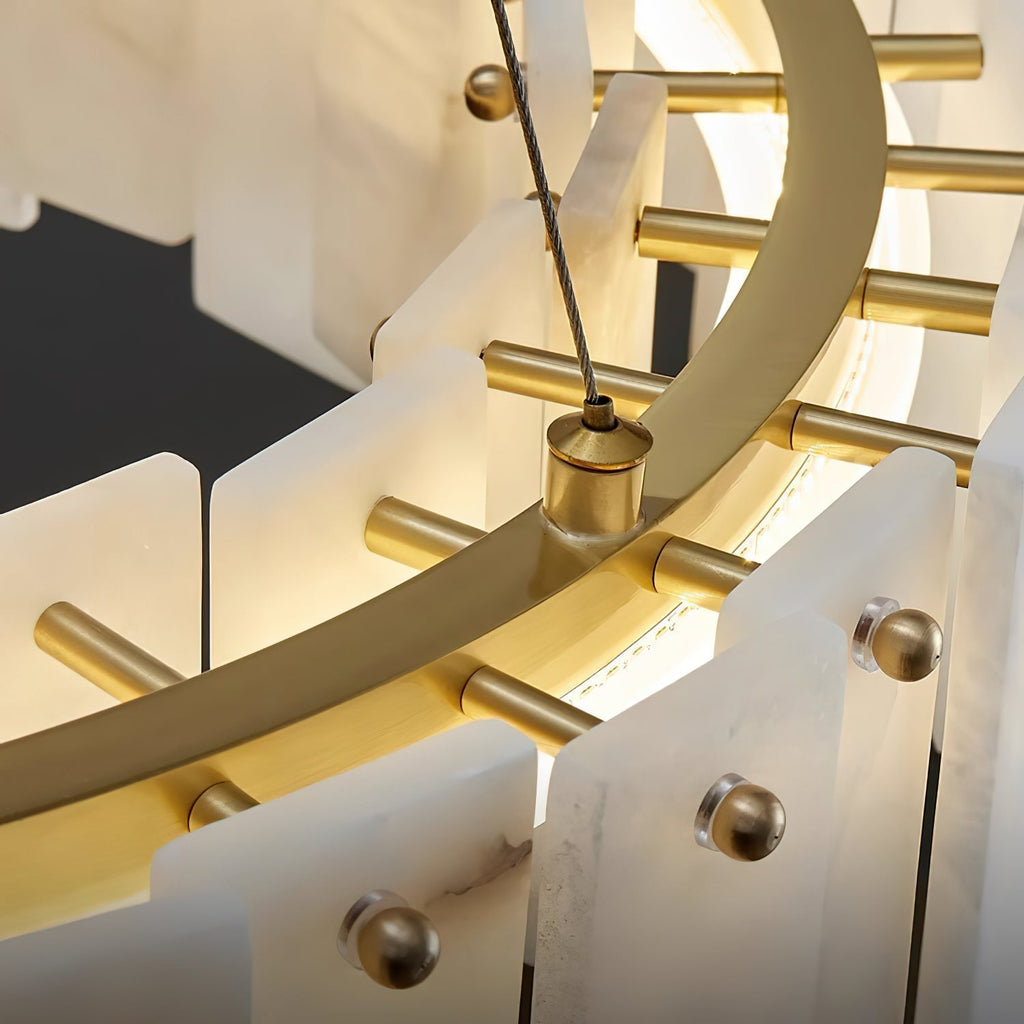 Detail of the Aero chandelier's brass inner ring and pins holding the alabaster panels, LED strip lit within