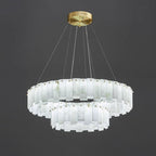 Two-tier Aero chandelier shown against dark grey, brass studs pinning each hand-shaped alabaster panel