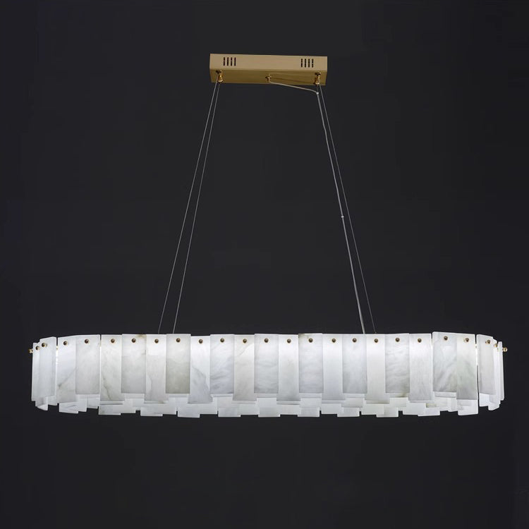 Aero alabaster chandelier in its long oval form, unlit against black with a rectangular brass ceiling bar