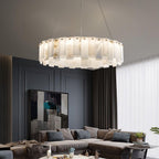 Lit above a sofa in a navy-panelled living room, with a large abstract canvas behind.