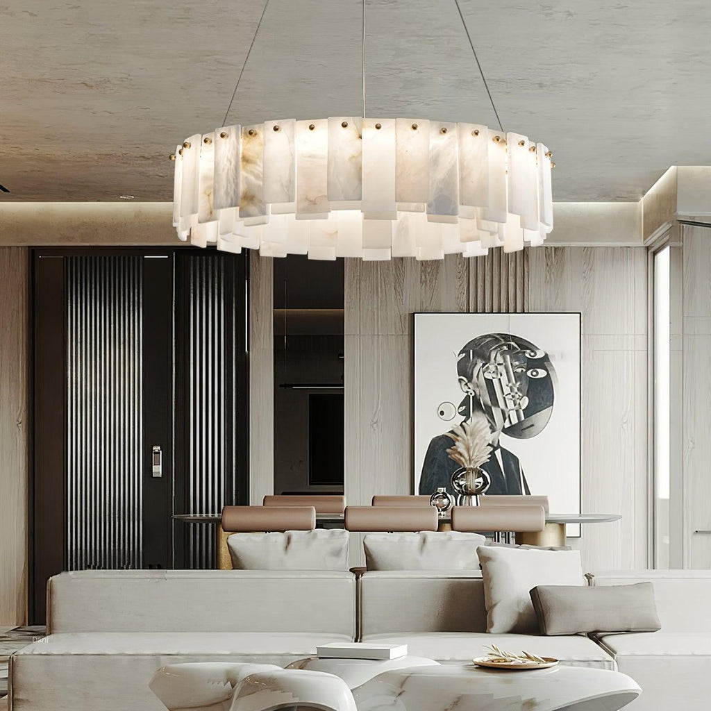 The chandelier lit in a stone-panelled living room, a framed portrait on the wall beyond.
