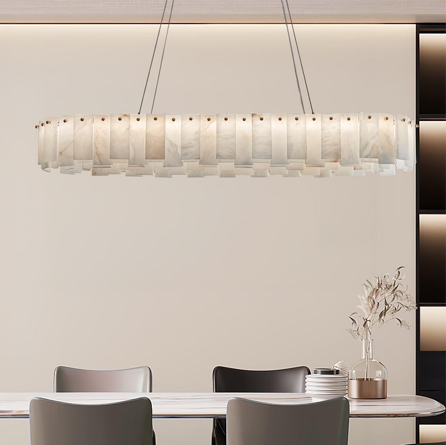 The long version lit above a dining table in a beige room with a tall shelving unit.