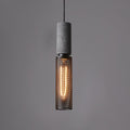 Cement-top pendant light with black wire cage over a kitchen island