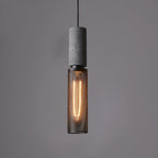 Cement-top pendant light with black wire cage over a kitchen island