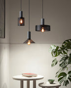 Cement mesh pendant light glowing over a kitchen worktop