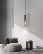 Cement-top pendant light with bare bulb and black wire cage