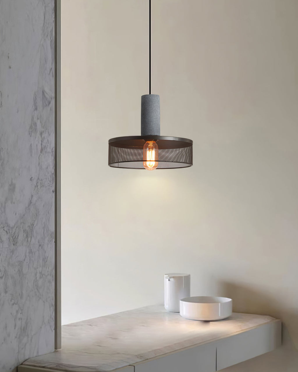 Cement mesh pendant light shadow play across a textured wall