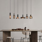 Wire cage pendant light projecting shadows across a ceiling