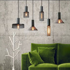 Cement-top pendant light with Edison bulb in an industrial kitchen
