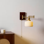 White ceramic wall lamp with brass hardware shown from the side