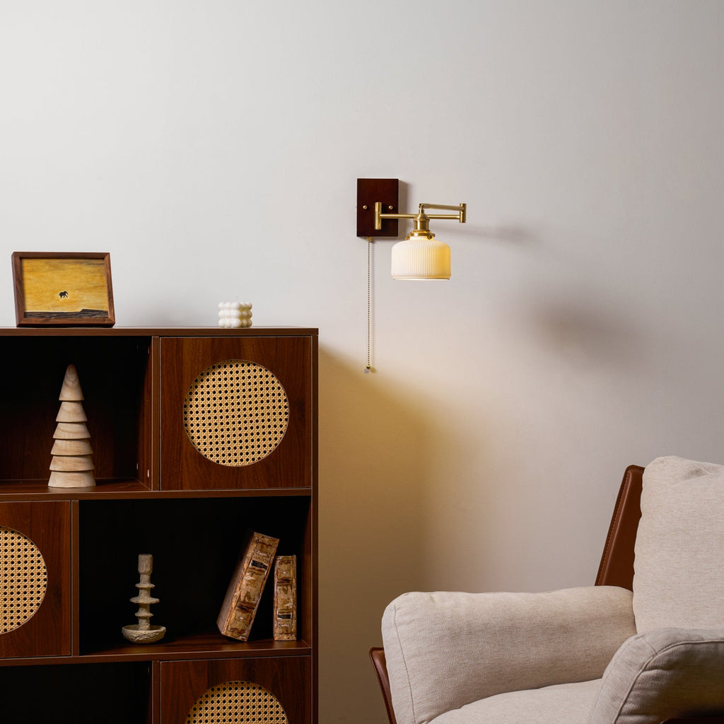 Ceramic wall lamp detail showing white shade and brass fittings