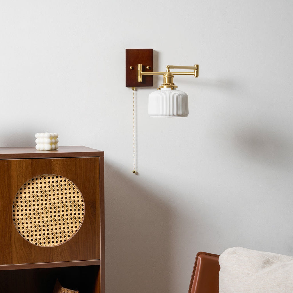 Ceramic wall lamp with white shade and walnut accent on a wall