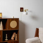White ceramic wall lamp with walnut accent mounted on a wall