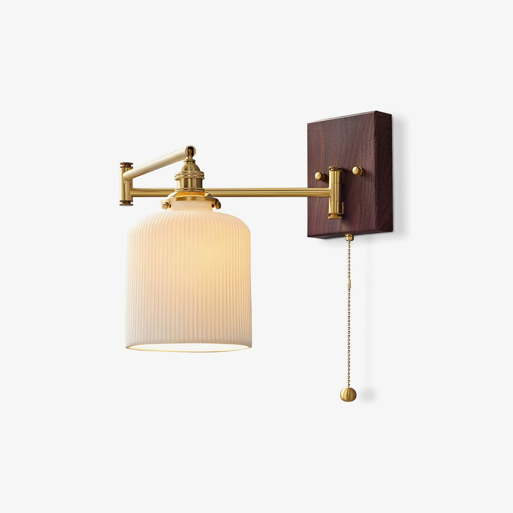 White ceramic wall lamp on brass mount shown against pale wall