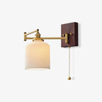 White ceramic wall lamp on brass mount shown against pale wall