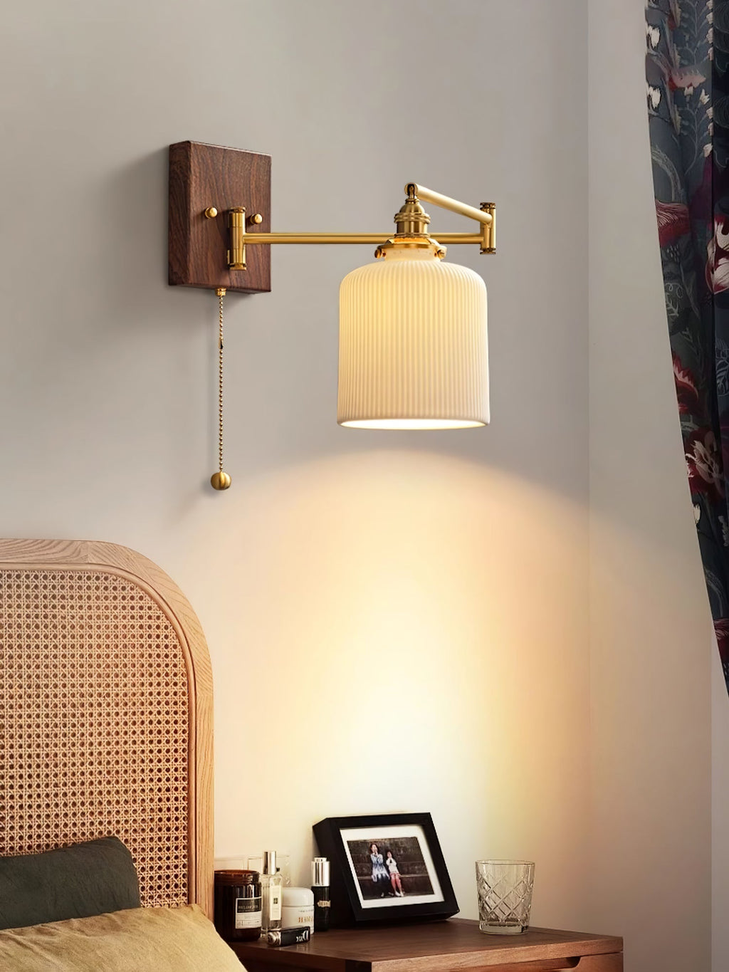 White ceramic wall lamp with brass and walnut in a warm interior