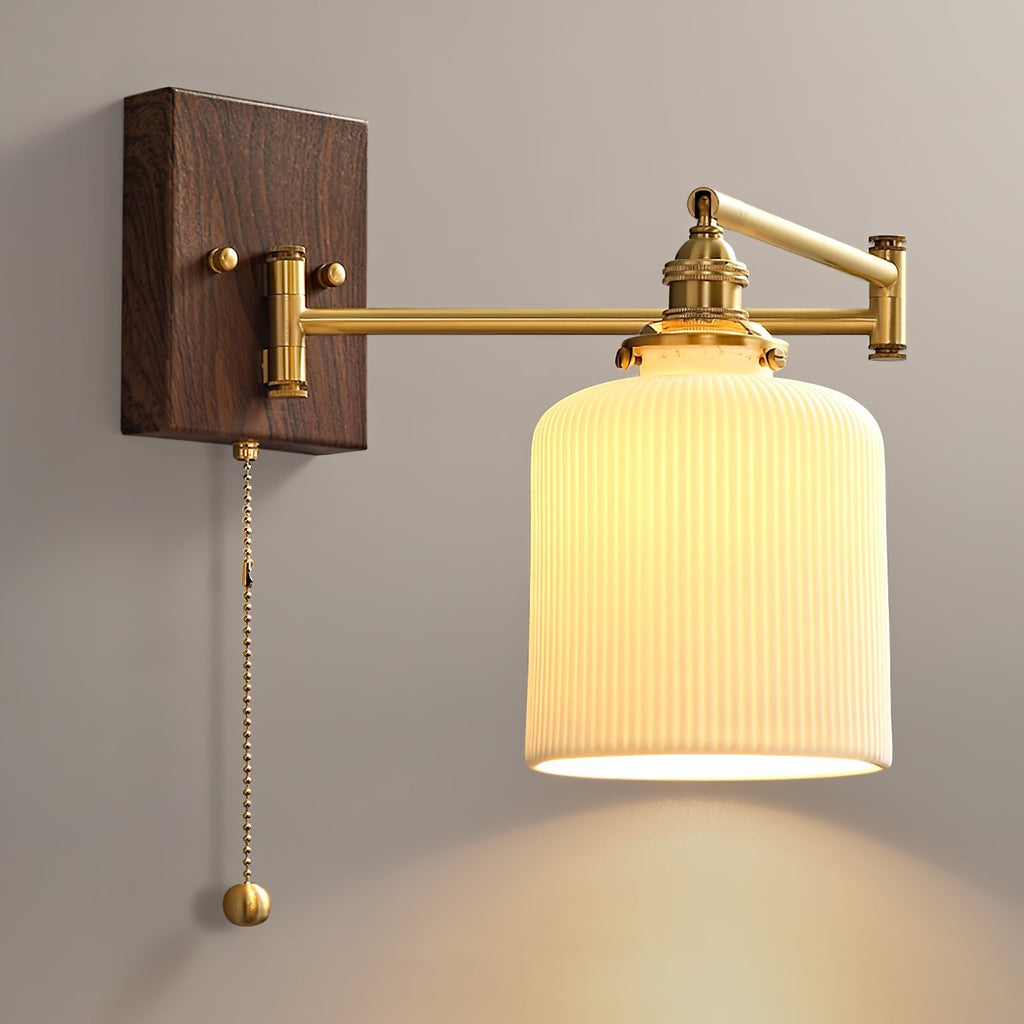 Ceramic wall lamp with brass arm and walnut accent against a wall