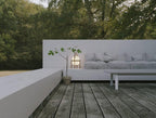 Wood-framed table lamp with white glass shade and warm glow
