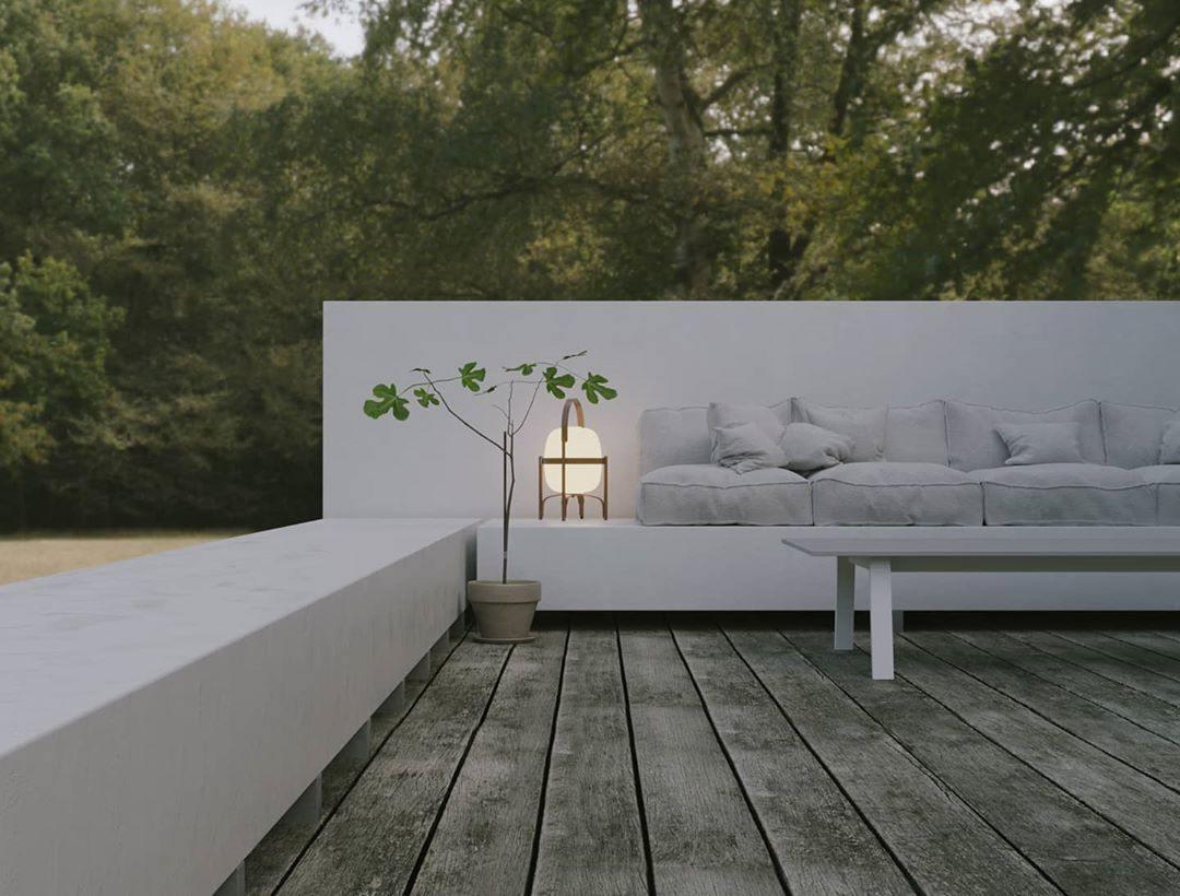 Wood-framed table lamp with white glass shade and warm glow