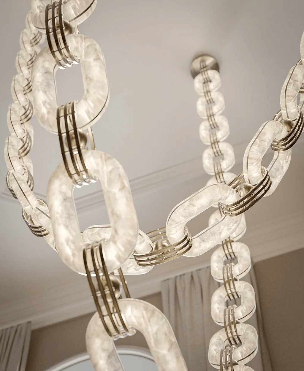Tall view of the lit chain, its alabaster links bright and the brass collars catching the light