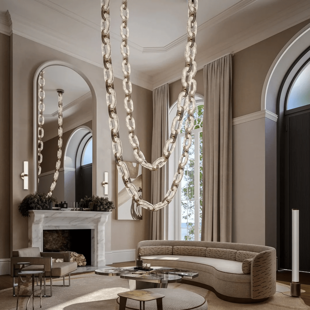 Chain-link chandelier draped in swags across a tall living room with a marble fireplace