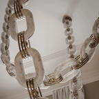 Looking up at the alabaster links and their brass banded collars, with the ceiling mount behind