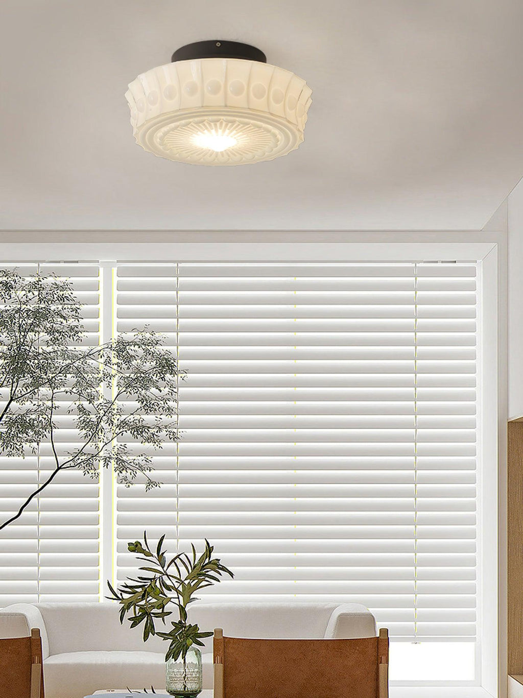 Black ceiling light with frosted glass shades glowing above a room