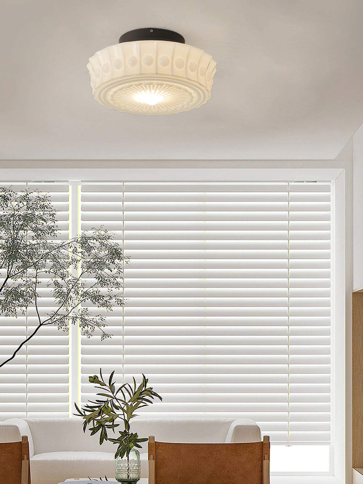 Black ceiling light with frosted glass shades glowing above a room