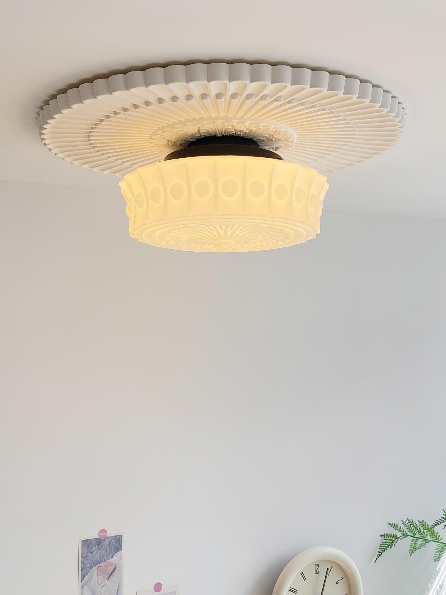 Ceiling light with black frame and white glass shades lit softly