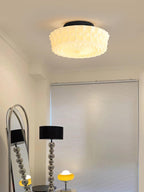 Black ceiling light with white glass shades shown in a bright room