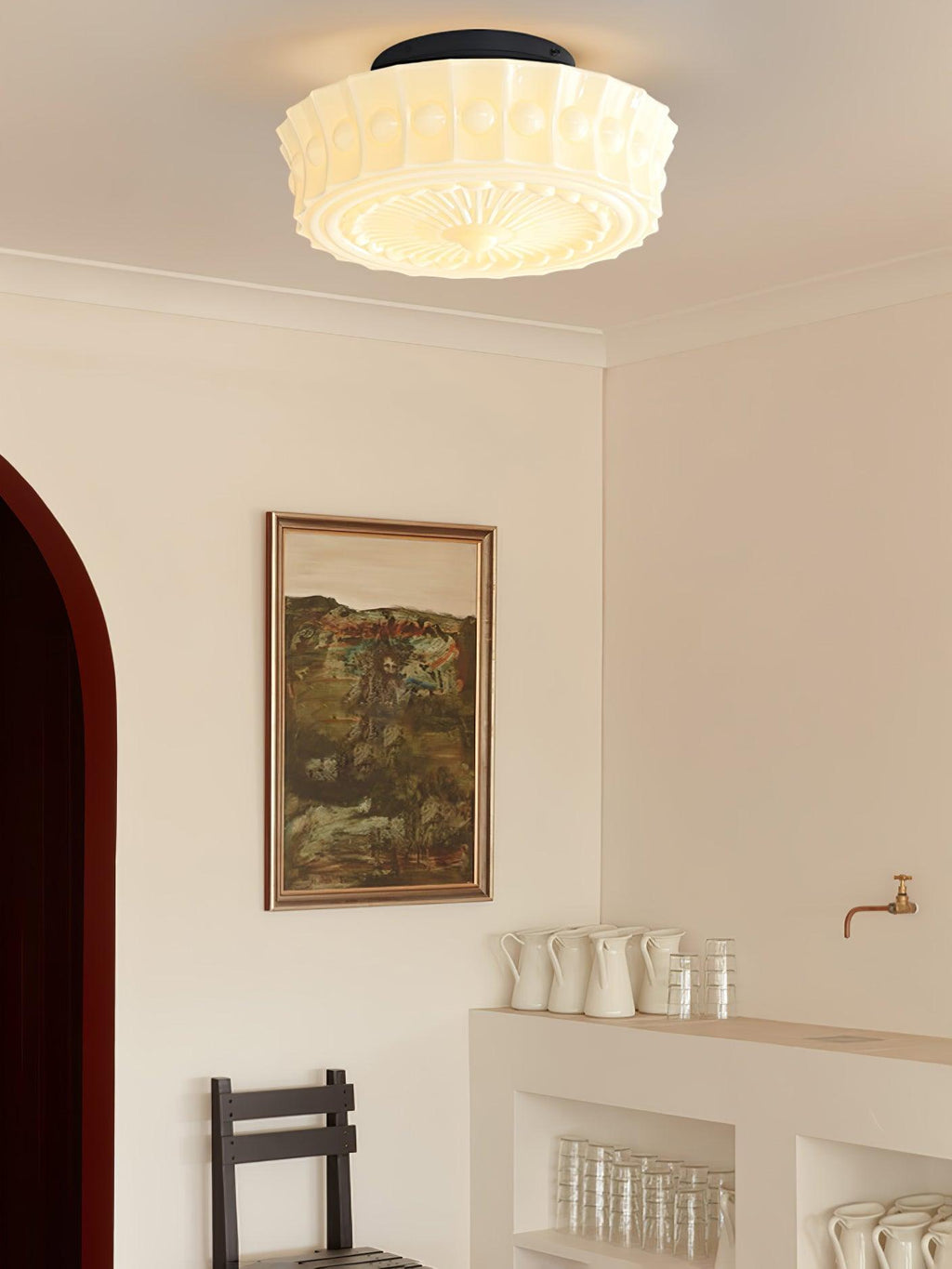 Ceiling light with black frame and glass shades casting warm glow