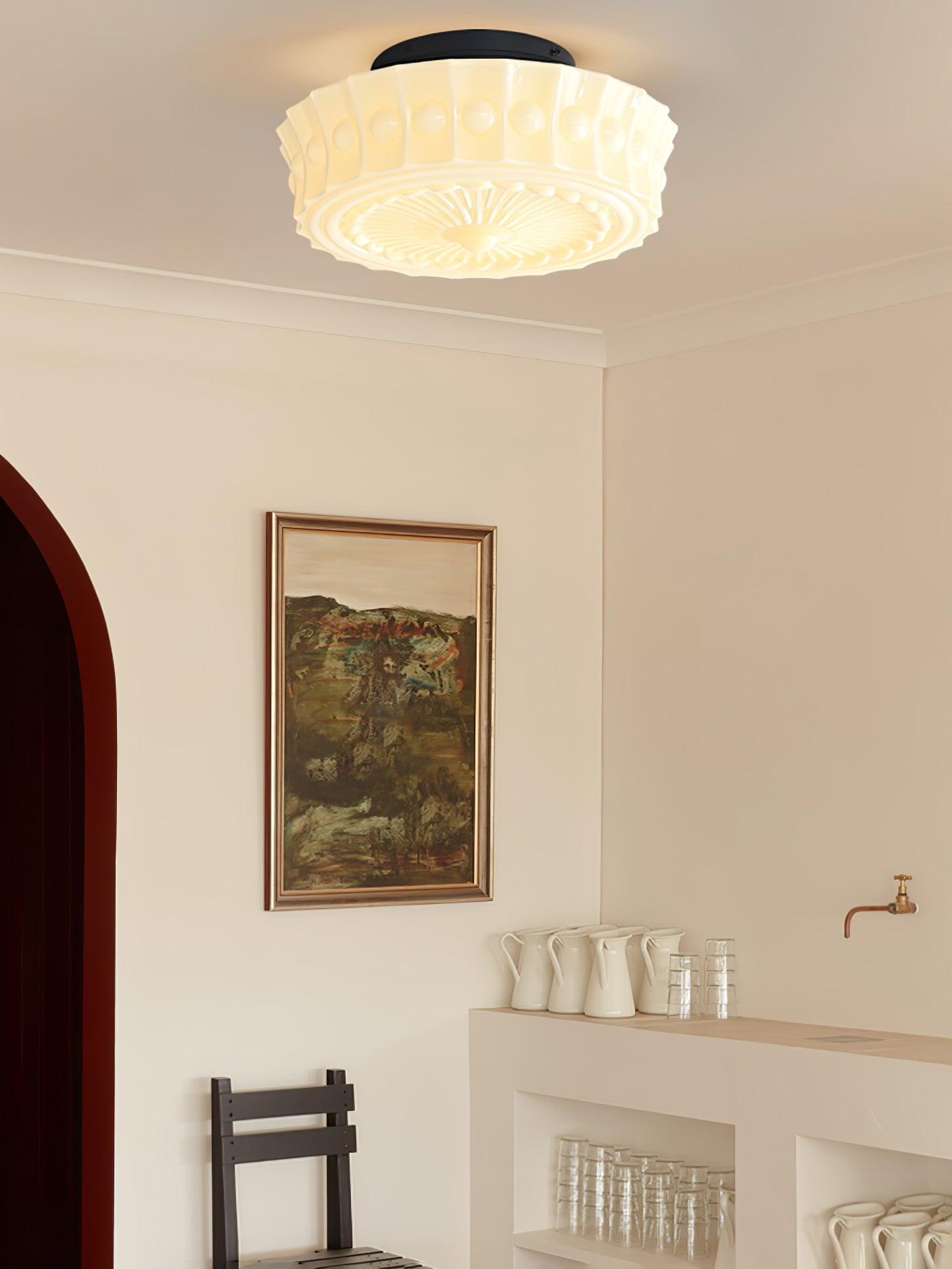 Ceiling light with black frame and glass shades casting warm glow