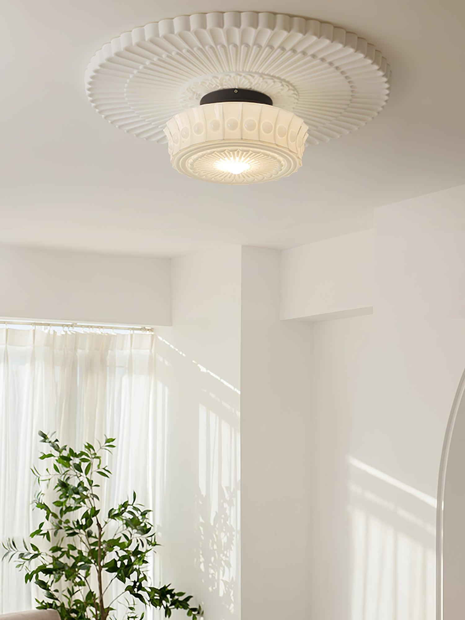 Glass shade ceiling light on black frame over a styled dining area