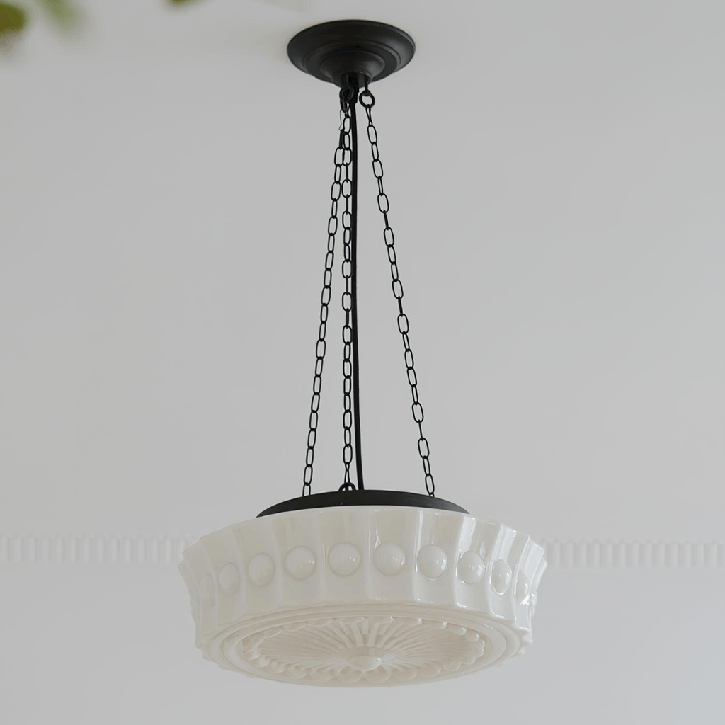 A studio view of this white fluted-glass Clérachic pendant on a plain background, showing the ribbed shade and sunburst diffuser plate.