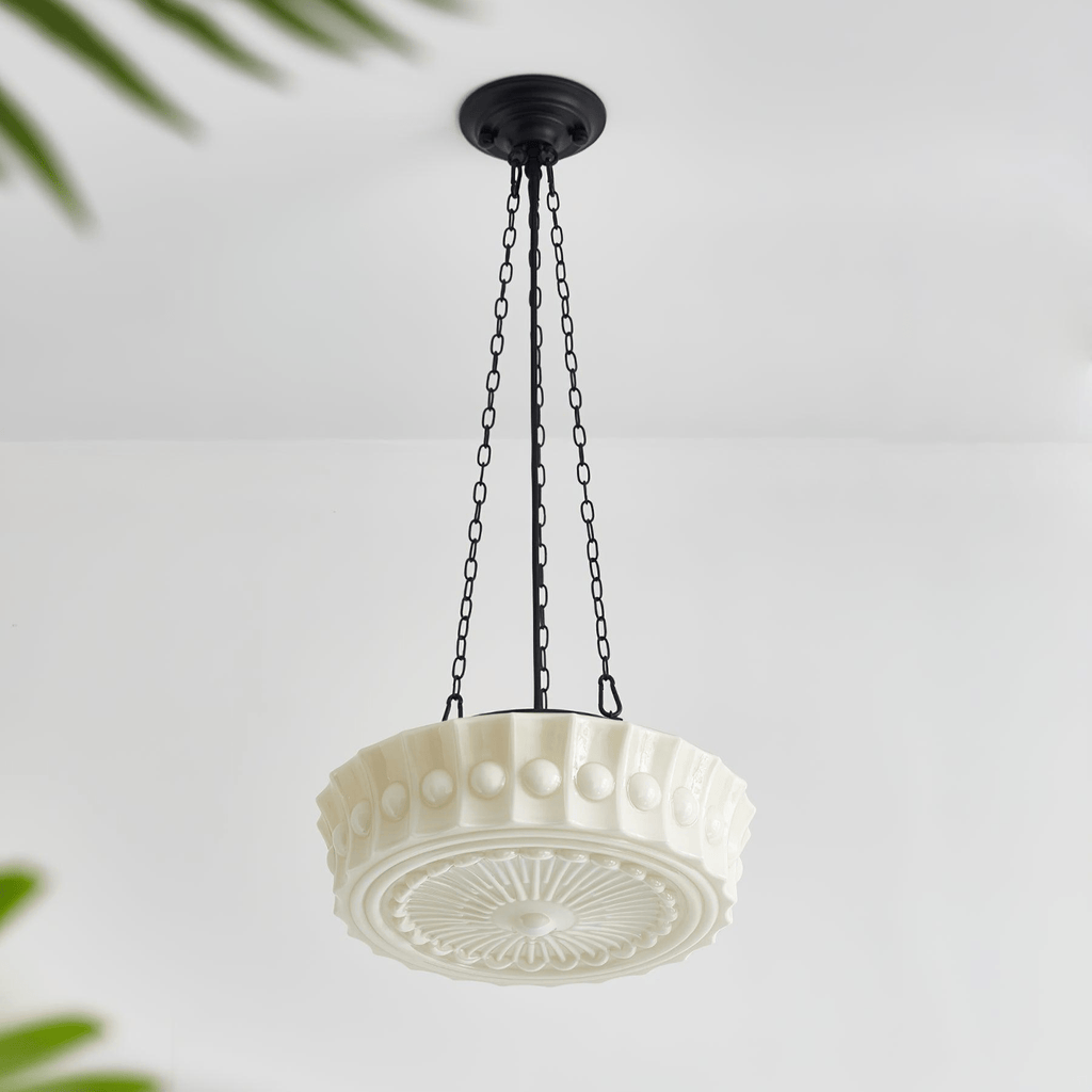 An angled studio view of this white fluted-glass Clérachic pendant, showing the fluted shade and sunburst diffuser from below.