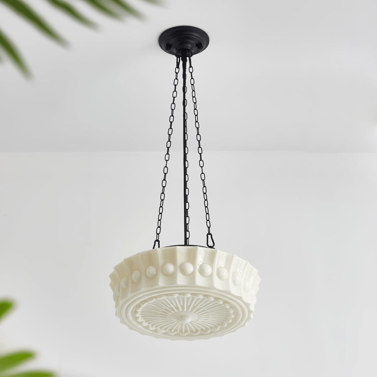 An angled studio view of this white fluted-glass Clérachic pendant, showing the fluted shade and sunburst diffuser from below.