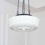 A close low-angle view of this white fluted-glass Clérachic pendant, showing the fluted ribs and sunburst diffuser in detail.