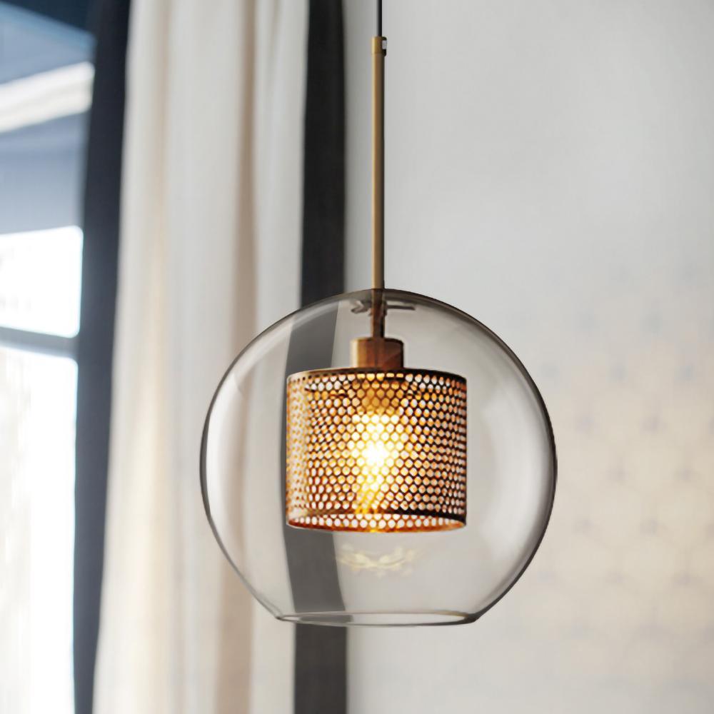 Blown glass pendant light with metal stem casting a warm glow