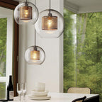 Blown glass pendant light with metal stem casting soft warm light