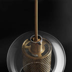 Blown glass pendant light casting a gentle warm glow indoors