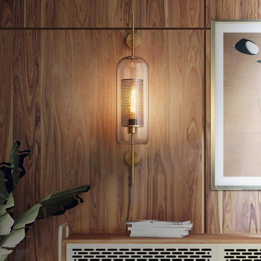 Hand-cut glass wall light casting a warm glow on the wall