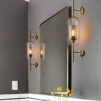 Glass globe wall light with slim stem lit softly in an interior