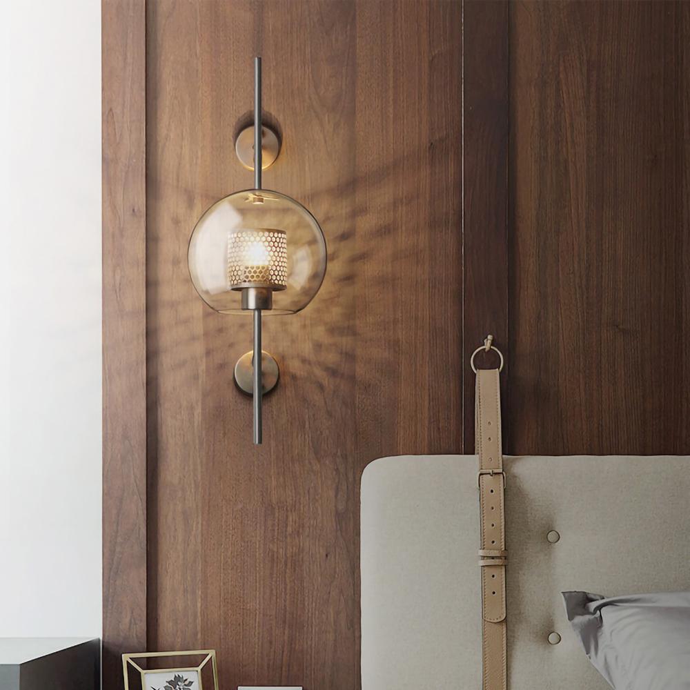 Glass globe wall light casting soft warm light on a wall